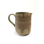 An early unglazed Carter,Stable Adams jug decorated in WC (geometric) design after James Radley