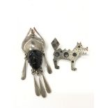 A modernist silver brooch modelled as a dog (stamped 800) together with a heavy silver and carved