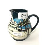 A Moorcroft Pottery single handled Trial jug with tube lined decoration and decorated in the