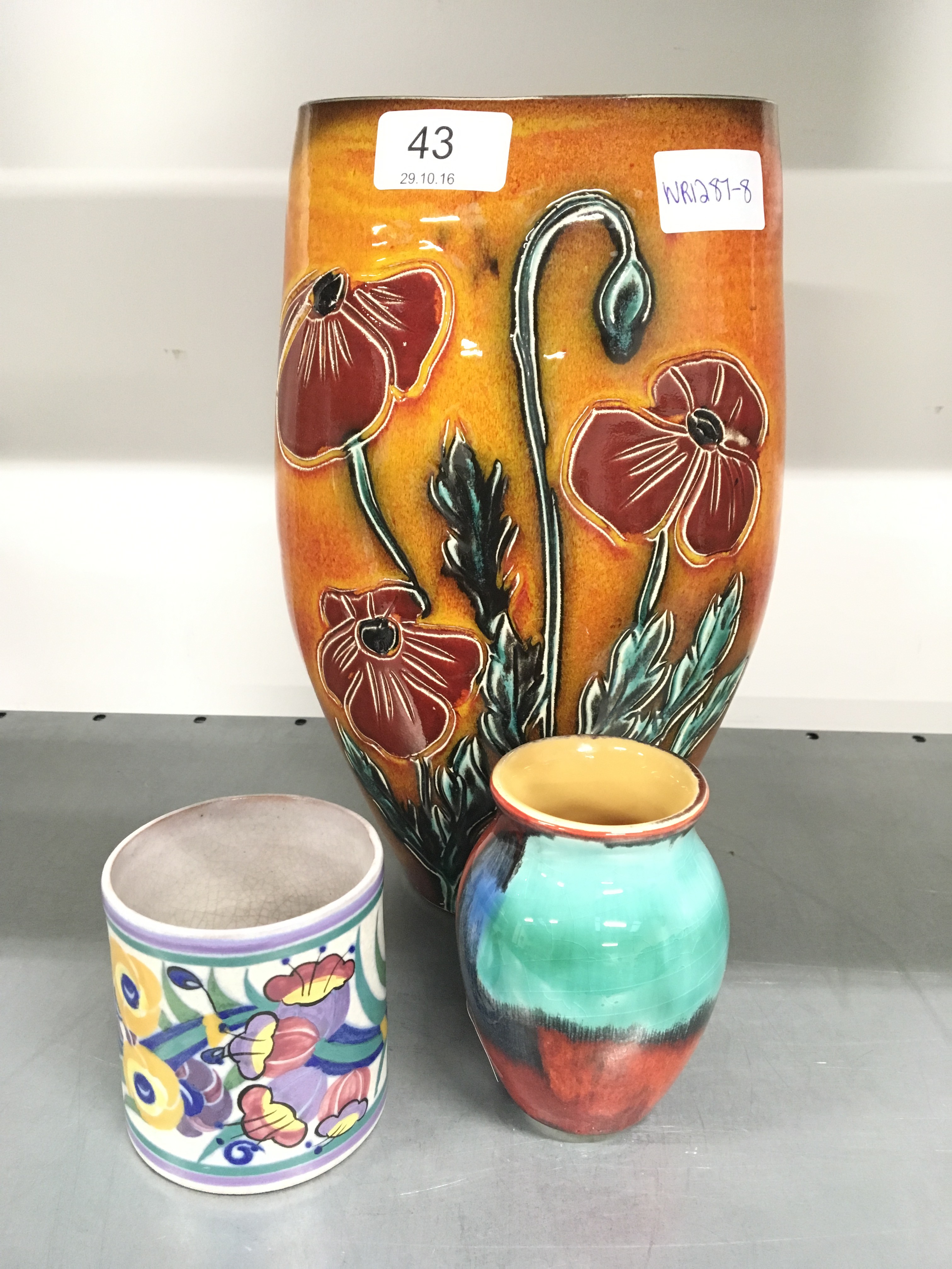 A Poole Pottery vase by Alan White, decorated with poppies together with a miniature Poole Pottery