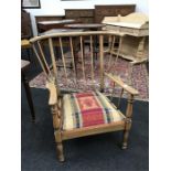 An Arts and Crafts style armchair with upholstered seat.