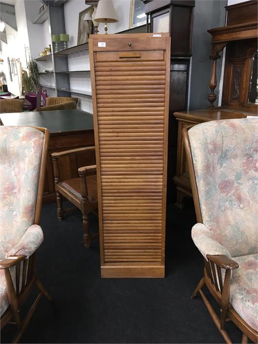 A mid-20th century tambour fronted bookcase in oak.