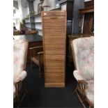 A mid-20th century tambour fronted bookcase in oak.