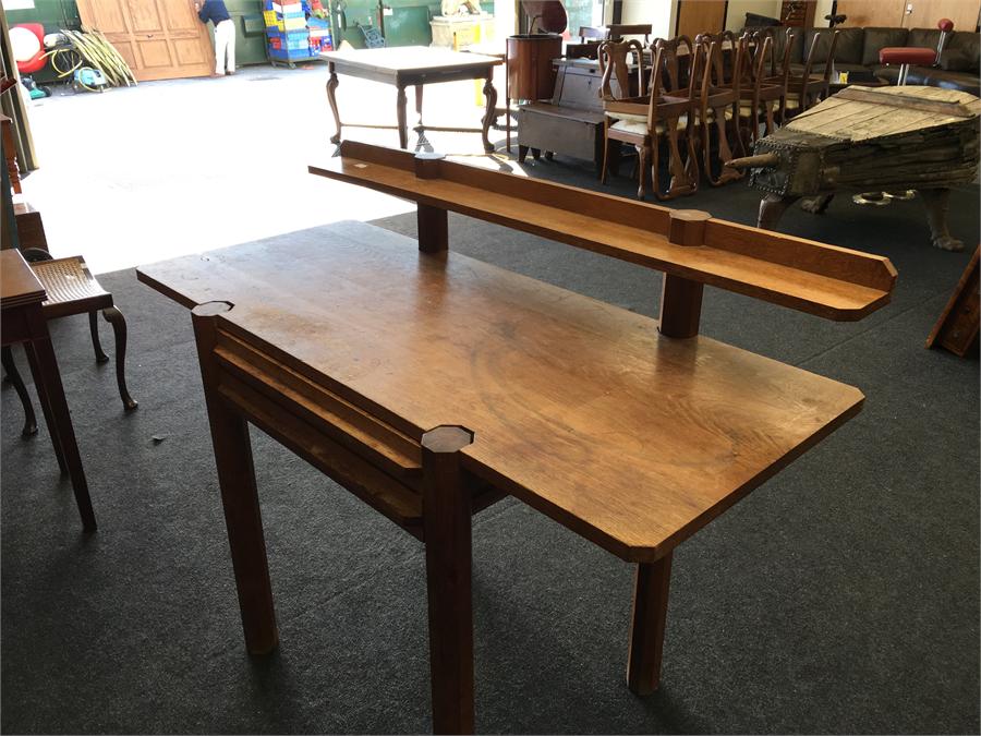 An Arts and Crafts oak buffet table with drawer to front and back shelf.