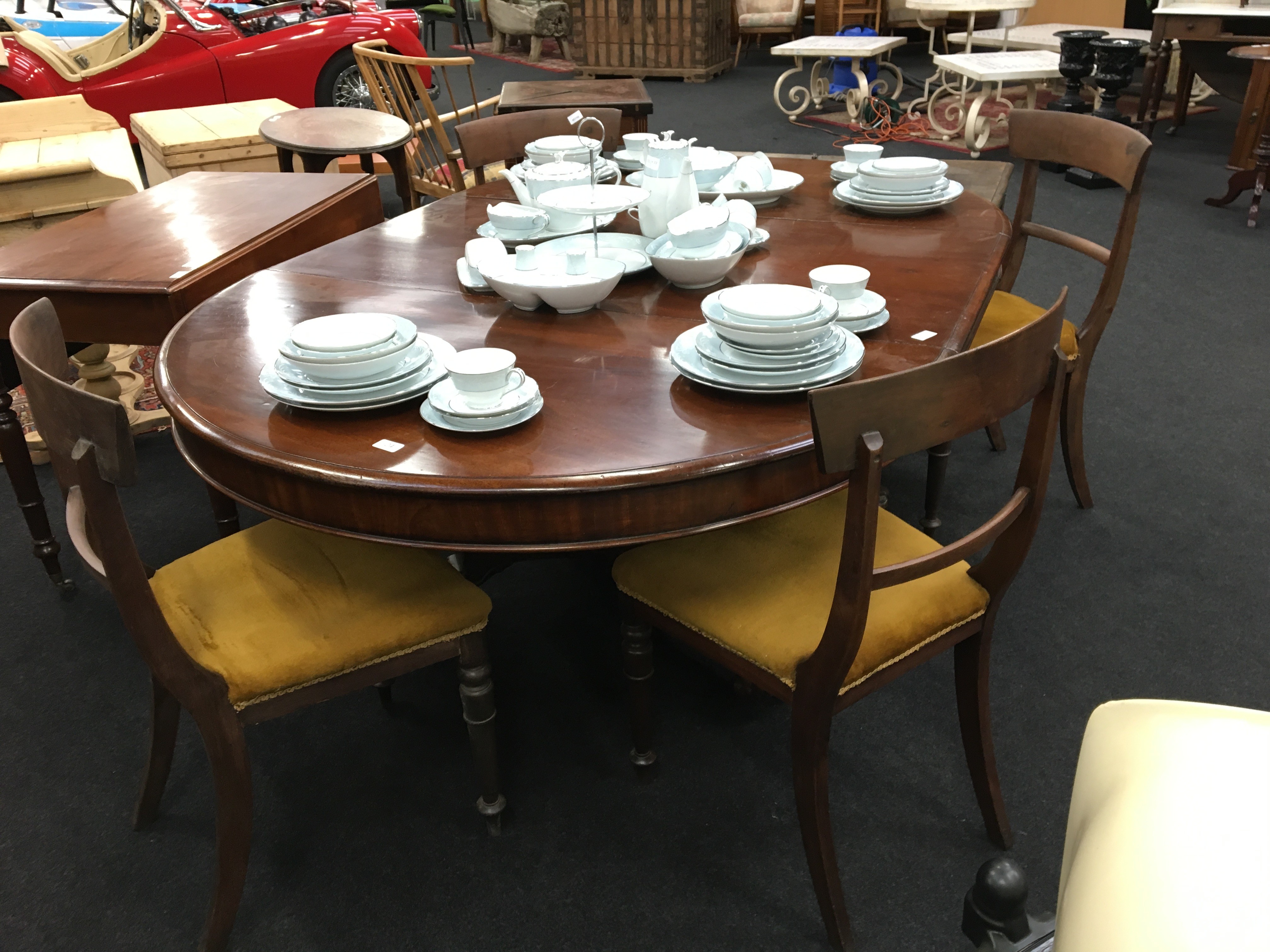 A 19th century mahogany dining room table resting on central column and paw feet together with