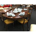 A 19th century mahogany dining room table resting on central column and paw feet together with