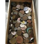 A wooden carton of mixed foreign and used coins.