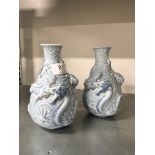 A pair of Spanish Lladro china blue glazed vases decorated with dragons (impressed markings to