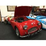 A Classic red Triumph TR3 First registered in 1957 and fitted with a 1991cc petrol engine.A historic