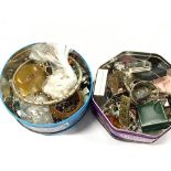 Two tins containing a large quantity of costume jewellery items to include white metal.