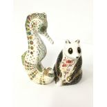 A Royal Crown Derby bone china paperweight modelled as a Panda together with another: Spot Seahorse,