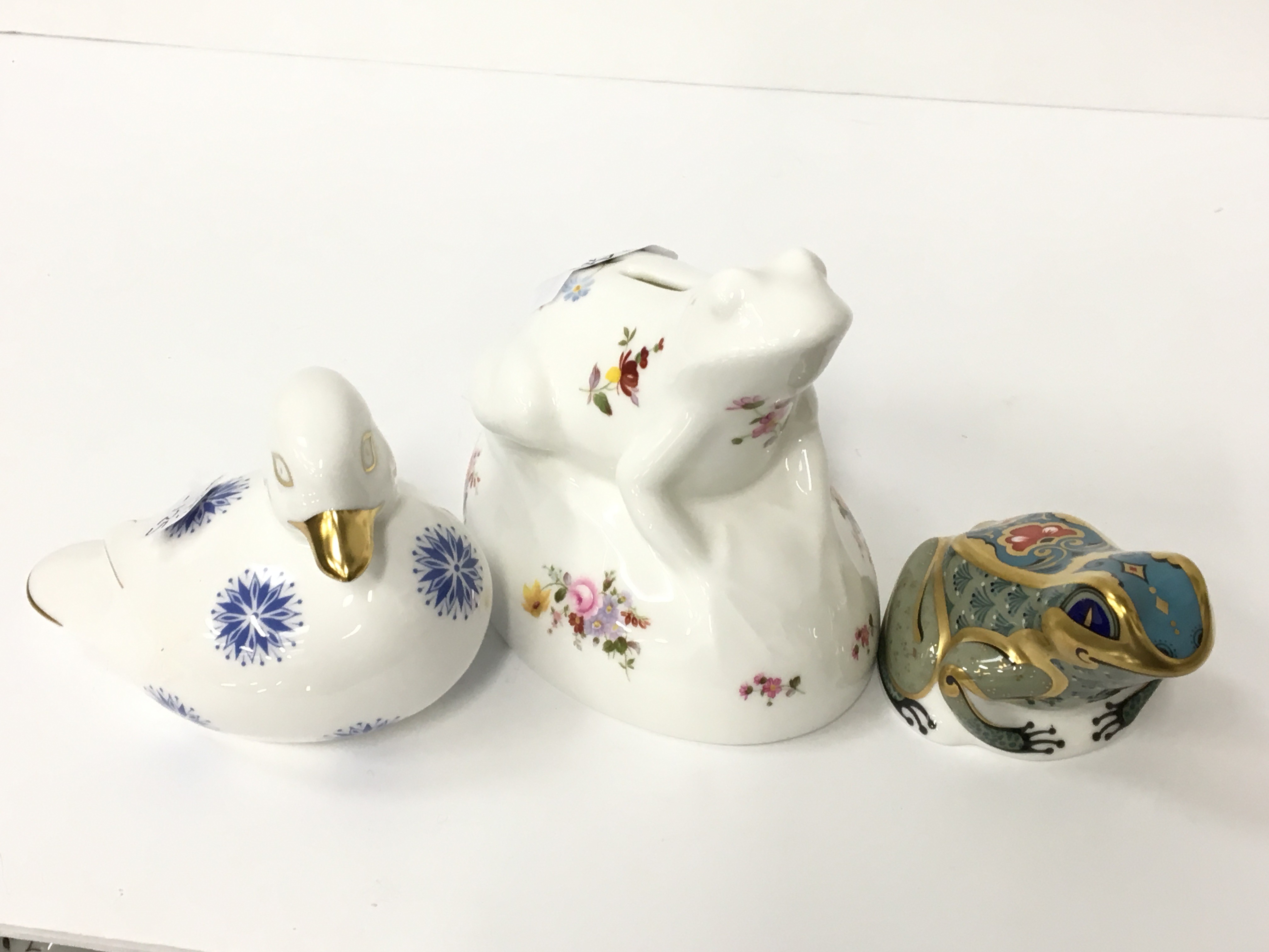 A Royal Crown Derby bone china paperweight: Fountain Frog, 2004, gold stopper, together with another
