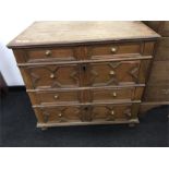 An 18th century oak chest of drawers with geometric design to drawer fronts and replacement