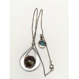 A Silver pendant with gold mounted Ruby and blue Topaz together with an Agate mounted silver pendant