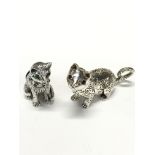 A silver novelty pin cushion modelled as a cat with inset with rubies and emeralds together with a
