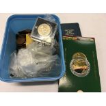 A carton containing silver and copper coins together with two New Zealand uncirculated coin sets,