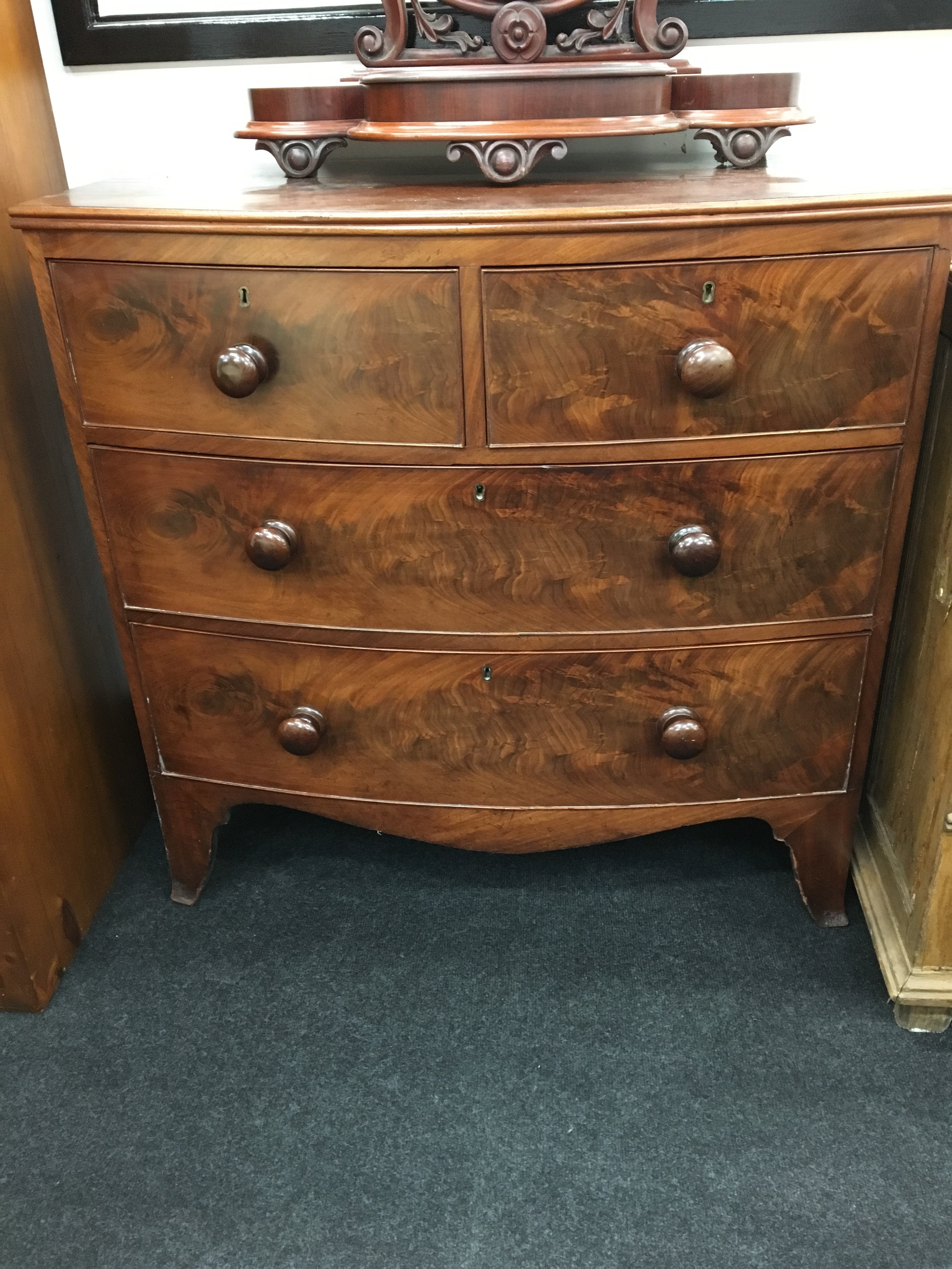 A Regency mahogany bow front chest of drawers on outswept bracket feet.