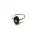 An 18ct gold carved Onyx and Diamond set ring. Size J.