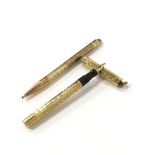 A gold plated cased eyedropper fountain pen together with a matching propelling pencil.