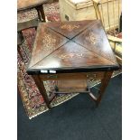 An Edwardian Rosewood envelope top card table with frieze drawer and under shelf.