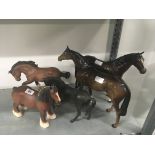 Two large brown glazed Beswick models of horses together with a black Beswick horse and two others.