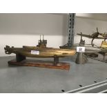 A World War brass cast model of a D Class 1908 submarine together with a pewter model of a