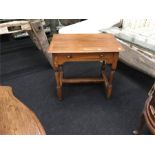 A 19th century side table in oak with drawer to front and H stretcher below.