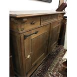 An Arts and Crafts style buffet which matches previous lot in oak with two doors to front with