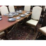An Arts and Crafts style oak dining room table with eight matching chairs.