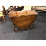 An oak gateleg dining table made by Rackstraw of Worcester.