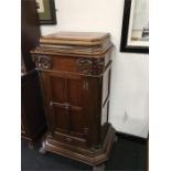 An Edwardian mahogany side cabinet with door and drawer to front, reeded columns to side resting