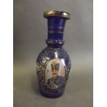 A small Ottoman blue glass decanter decorated with gilt and white enamels and a portrait of an