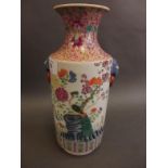 A Chinese porcelain cylindrical vase with mask ring handles, decorated in the famille rose palette