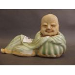 A celadon glazed stoneware figure of Buddha reclining, 6" long (AF)