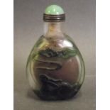 A Peking glass snuff bottle with raised decoration of figures cloud gazing on a green ground, 3"