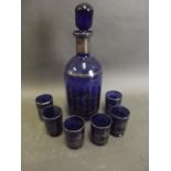 A Venetian blue glass decanter and stopper, and six shot glasses decorated with a Venetian scene