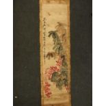 A Chinese hand painted scroll decorated with a dragonfly and foliage, with calligraphy and seal