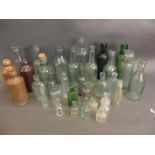 A collection of various antique bottles and stoneware jars (32)