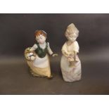 A Spanish Zaphir porcelain figure of a young girl with a basket of flowers, with original box, and