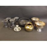 Four small lead classical urns, a pewter fruit bowl, two silver plate pedestal bowls, a