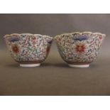 A pair of Chinese porcelain bowls with flared rims decorated with flowers in bright enamels, seal