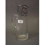 A glass jug with silver overlaid decoration, 10" high