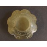 A small Chinese jade brush pot carved with carved decoration of symbols and inscriptions, 2"