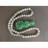 A small carved jade figure of Quan Yin, and a string of jade beads, figure 2½" long