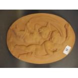 An oval terracotta plaque depicting two cherubs, 14" x 10", Best Bid