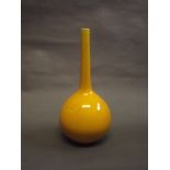 A Burmantofts long necked bulbous vase with a deep yellow glaze, 10½" high