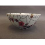 A Chinese crackle glazed stoneware bowl decorated with prunus blossom and birds, 5½" diameter