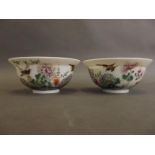 A pair of fine porcelain bowls decorated in bright enamels with flowers, birds and insects, 6