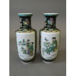 A pair of Chinese famille noire porcelain vases with decorative panels of women and children in