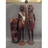 A pair of large African carved hardwood figures of a warrior with spear and shield, and his wife